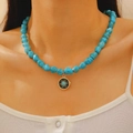 Bohemian turquoise beaded necklace with gold sun pendant worn on a model's neck - Black Base Sun Pattern Style (kc金10803)