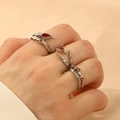Three-piece punk style silver rings set with red gemstone accents on model's hand - Vine Thorns Style (3 Piece Set)