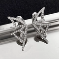 Detailed macro view of silver geometric stud earrings with pavé set crystals on a metal tray - Geometric Rhinestone Silver (K-1562)