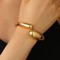 Minimalist bold golden wide spring cuff bracelet with liquid drop design on female wrist - Chunky Water Drop Bangle (9070) / KC Gold