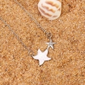 Minimalist silver starfish pendant necklace with opal inlay on sandy beach background - White Alloy WG-1371