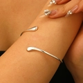 Macro view of S925 sterling silver liquid lava arm cuff with teardrop shaped ends - S925 Water Drop Open Bangle (11157) / Bright Silver