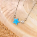 Close-up of blue opal starfish pendant with silver chain on shell and sand - Blue Alloy WG-1365 (15 White Gold Tone)
