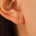 Macro shot of a tiny gold dragon stud earring worn on ear featuring detailed wings and tail - KC Gold Flying Dragon Stud Earrings (11416)