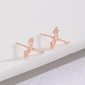 Macro detail of rose gold dragon stud earrings with intricate wing and tail carving - Flying Dragon Stud Earrings (5298) / Rose Gold