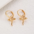 Macro shot of gold dragon pendant earrings with detailed wing texture and polished finish - Dragon Pendant Hoop Earrings (K-815) / KC Gold