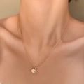 Rose gold mermaid shell and star pendant necklace worn on a woman's collarbone - Rose Gold Shell Star Style (5431)