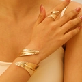 Detail of adjustable golden leaf texture bracelet and ring set on female model - Bracelet and Ring Set in Gold (K-554+K-548)