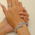 Elegant silver feather jewelry set with sparkling stones on model hands - Bracelet and Ring Set in Silver (DZ-319+4924)