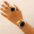Exaggerated snail-style gold metal bracelet and ring set with black oval gemstone - Bracelet and Ring Set in Gold 5713