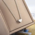 Elegant silver heart pendant necklace with delicate chain on a brushed jewelry box - Silver (02 White K Necklace 11089)