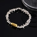 Minimalistische kralenarmband met zilveren kralen en een gouden hartvormige hanger - Zilveren Ovaal Armband 0611