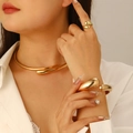 Polished gold teardrop jewelry set with necklace, ring and bracelet on model - Wide Neck Collar + Bangle + Ring Three-Piece Set / Gold