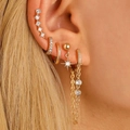 14K gold hoop earrings set with micro-paved zircons and star pendant on model ear - Gold Octagonal Star Chain Earring (3190)