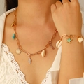 Detail view of bohemian gold chain set featuring natural sea shells and starfish charms - Gold Starfish Necklace And Bracelet Set(9645+5735)