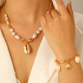 Detail of bohemian gold chain set with natural cowrie shells and pearls on a model - Artificial Pearl Shell Necklace And Bracelet Set(5755+8459)