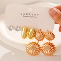 Detailed view of a three-piece gold earring set with studs, hoops, and floral pendants - 02KC Smooth Gold (Style 2)