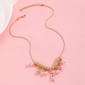 Detail of gold snake chain necklace with pink ribbon pendant and crystal charms - Gold Snake Chain Necklace (G-296)
