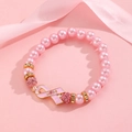 Macro detail of a pink pearl bracelet featuring a pink ribbon hope charm for breast cancer - Pink Artificial Pearl HOPE Bracelet (G-556)