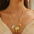 Dettaglio di una collana bohémien oceano con ciondoli a stella marina e conchiglia su modella - Collana / Giallo 8286