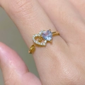 Macro view of gold heart arrow ring with purple gemstone and sparkling zircon stones - Heart Arrow (35030342) / Adjustable / Gold