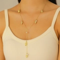 Detail of a gold Y-shaped necklace featuring conch charms and elegant white pearls - Marine Y-Shaped Pendant Necklace (6527)