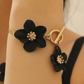 Elegant gold necklace with double black flowers and vintage toggle clasp detail - Black Flower Bracelet (KC Gold Large Flower Center 3607)