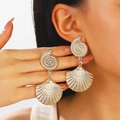 Gold ocean themed starfish and seashell earrings worn by a model in a luxury style - Nautilus Scallop Exaggerated Drop Earrings (N-977)