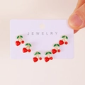 Three pairs of cute red cherry stud earrings with green leaves on a white card display - Cherry Stud Earrings Set (25010522) / Light Gold (X303)