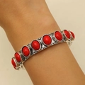 Detail of bohemian silver bracelet with nine oval red stones on a model's wrist - Red Stone Style (A-561)