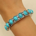 Close-up of vintage bohemian silver bracelet with turquoise stones on a model's wrist - Turquoise Stone Style (A-544)