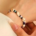 Close-up of Bohemian handmade beaded bracelet with natural shell and colorful beads on wrist - Ocean Conch Style (44 Conch 3610)
