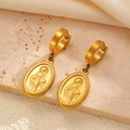 Detailed macro of gold plated Virgin Mary medallion earrings on textured stone surface - Gold Virgin Mary Medal Style (10641)