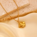 Macro detail of golden fish pendant with fine stripes on silk fabric and stone background - Carved Striped Small Fish (S107) / 18K Gold