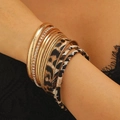 Close-up of stacked leopard print leather bracelets with gold textured and crystal bangles - Embossed Leopard Style (A-631)