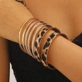 Detail of stacked leopard print and gold hammered bracelets on a female wrist - Hammered Leopard Style (A-1158)