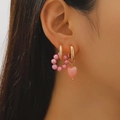 Asymmetric pink pearl and ceramic heart drop earrings on model for women - Pink Heart Pearl Style (10676)