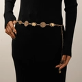 Detail of vintage gold geometric metal waist chain with tassels on black dress - Gold Vintage Disc & Rhombus Style