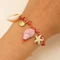 Detail of woven beach bracelet featuring ceramic starfish, shell charms and red cords - Red Woven Pendant Style (16 Red 0643)