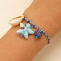 Detail of handwoven nautical bracelet with shell, ceramic starfish and purple rhinestone charm - Deep Blue Shell Starfish (17 Deep Blue 1609)