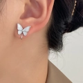 Silver butterfly clip-on earring with mother of pearl inlay on model ear - Mother of Pearl Texture Butterfly Ear Clip (08 Thick White K S186)