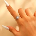 Macro detail of silver sunflower open ring with radial pattern on model's finger - Steel Silver (1376)