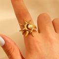 Detail shot of a sun-shaped 18k gold plated ring featuring a glowing cat-eye stone - 18k Gold Plated (X559)