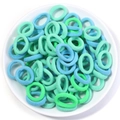 Macro shot of blue and green elastic hair bands in soft ribbed fabric on a white dish - 2cm Diameter / Green System