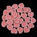 Macro shot of two-tone pink resin heart charms for DIY crafts and jewelry making - Pink