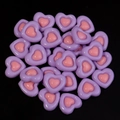 Macro view of pink and purple heart resin flatback charms for DIY handmade crafts - Purple