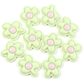 Flat lay of 10 mint green resin flower charms with pink centers for DIY hair clips - Size Approx 30x36mm / Green