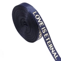 Macro view of dark blue ribbed ribbon with gold LOVE IS ETERNAL lettering for gift wrapping - 1cm Wide / Navy Blue