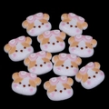 Macro view of 10 white resin cartoon dog charms for DIY crafts and phone case decor - 17x22mm / White & Yellow Sunglasses Puppy