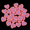 Macro shot of dual-tone pink and purple resin heart cabochons for DIY crafts - Watermelon red